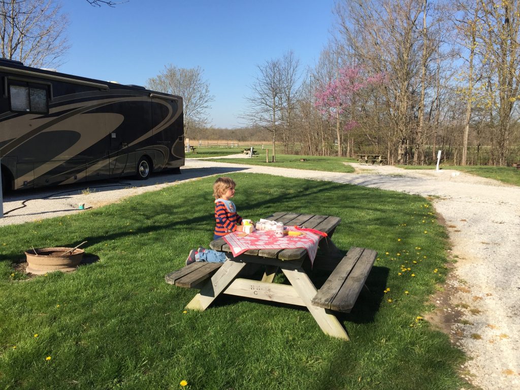 Ein Tisch mit Kind auf einem Campingplatz
